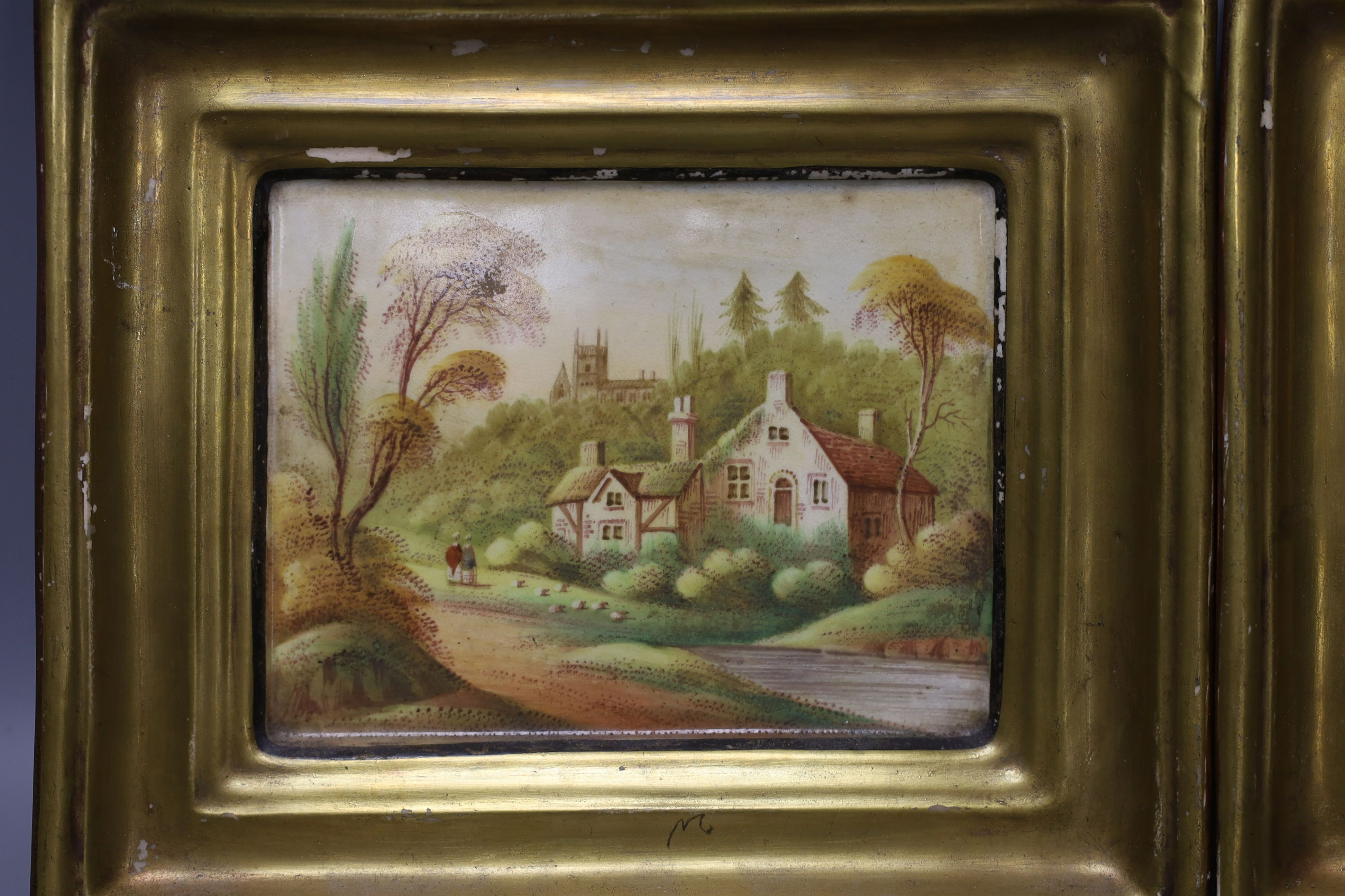 A pair of 19th century painted pottery hanging wall plaques depicting village scenes - 17 x 20cm